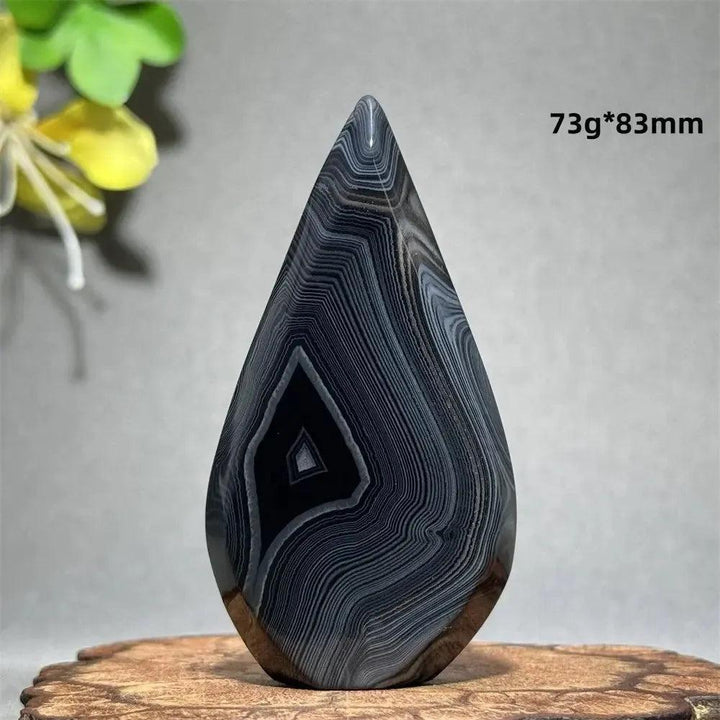 Polished Black Agate Freeform Torch with deep black, white, and gray banding, promoting grounding and protection.