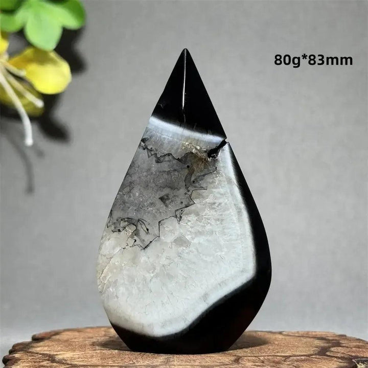 Polished Black Agate Freeform Torch with deep black, white, and gray banding, promoting grounding and protection.