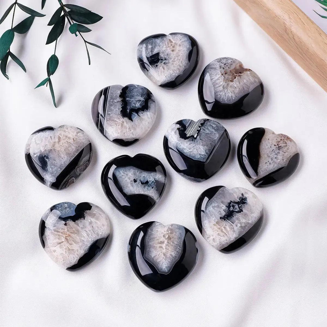 Crystal Destiny black agate heart palmstones with polished surfaces and sparkling druzy crystal cave formations.