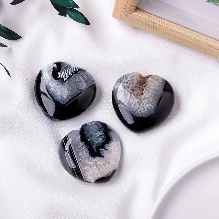 Three polished black agate heart crystals with sparkling druzy geode centers from Crystal Destiny.