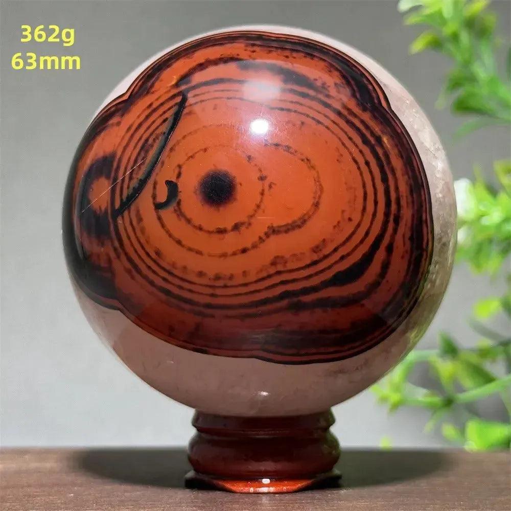 Black Banded Agate Sphere with Stand, showcasing dramatic deep black and charcoal gray striations.