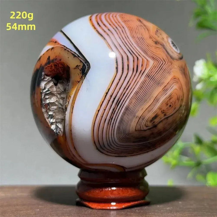 Polished Black Banded Agate Sphere with Stand, showcasing dramatic black, charcoal, and white striations.