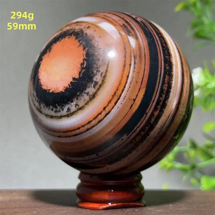 Black Banded Agate Sphere with Stand, showcasing dramatic black, charcoal, and white striations.