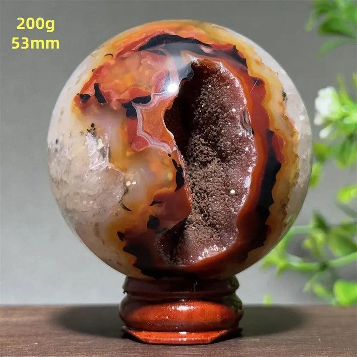 Polished Black Banded Agate sphere with dramatic striations, deep black, charcoal gray, and white bands.