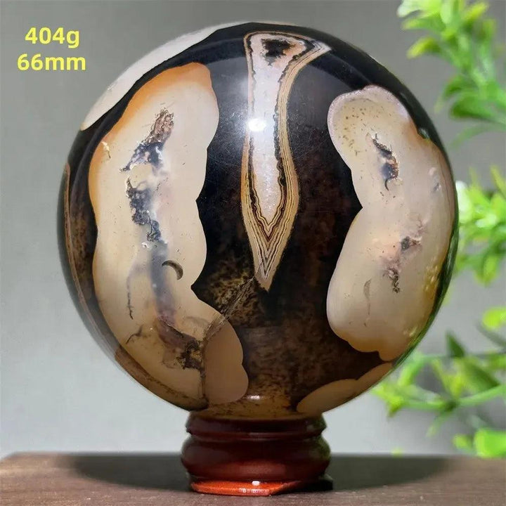 Black Banded Agate Sphere with Stand, showcasing dramatic black, charcoal, and white striations for grounding energy.