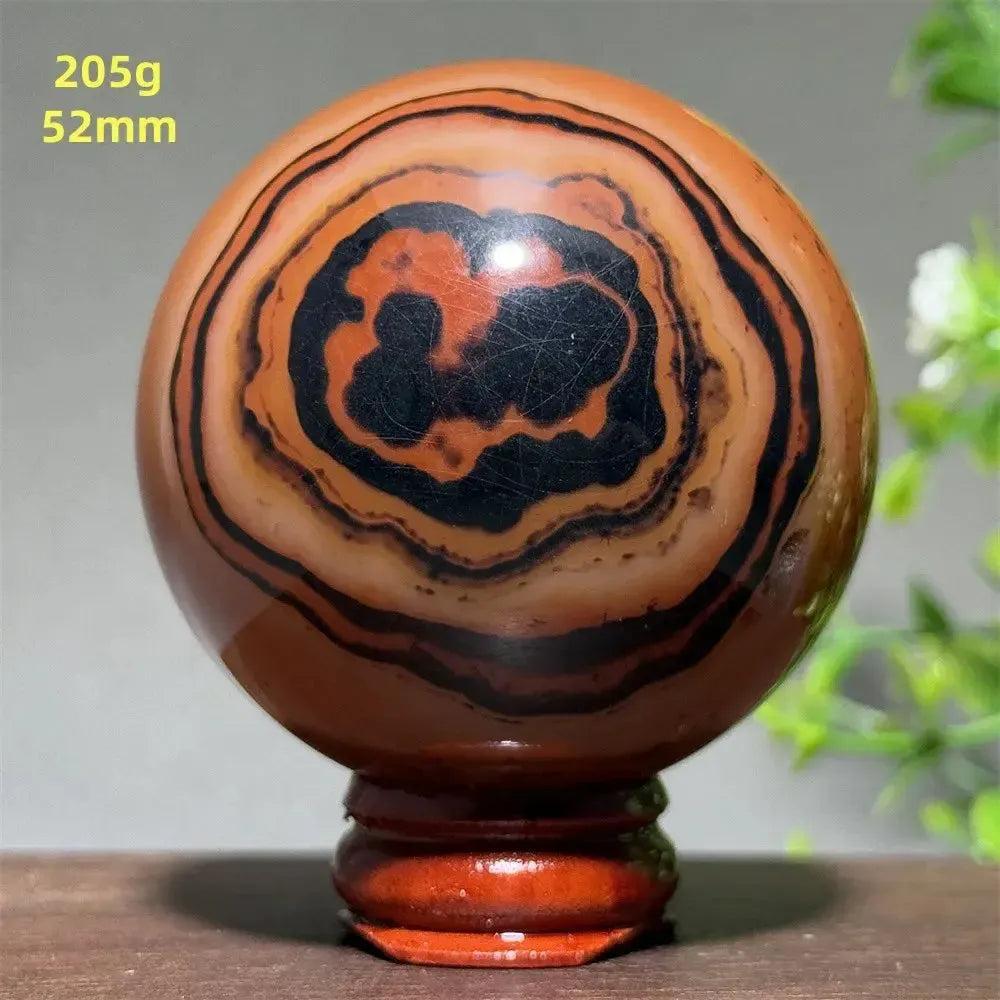 Black Banded Agate Sphere with Stand: Polished sphere showcasing dramatic black and charcoal gray striations.