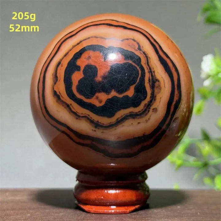 Black Banded Agate Sphere with Stand: Polished sphere showcasing dramatic black and charcoal gray striations.