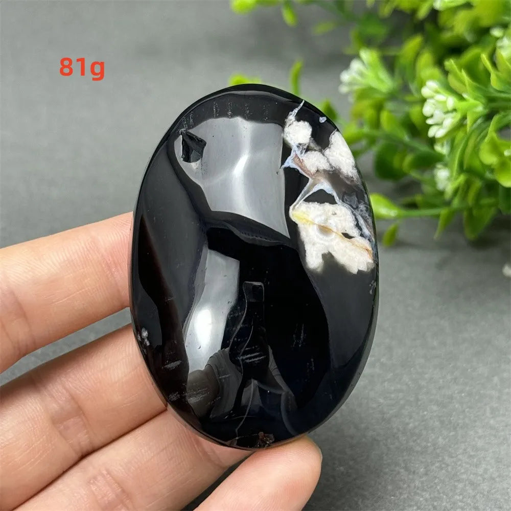 81g Black Cherry Blossom Agate palm stone with a deep charcoal base and elegant cream floral dendrite patterns.