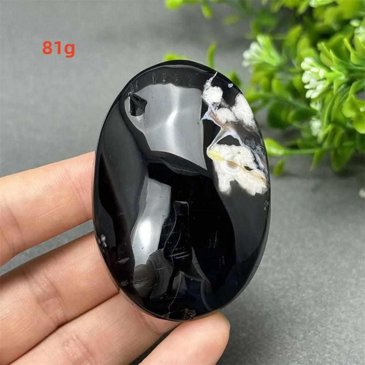 81g Black Cherry Blossom Agate palm stone with a deep charcoal base and elegant cream floral dendrite patterns.