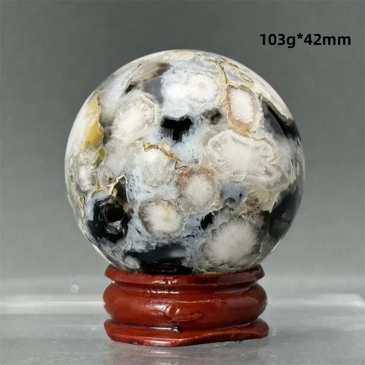 Black Cherry Blossom Agate Sphere, 42mm, with dramatic dark and light floral patterns on a wooden stand.