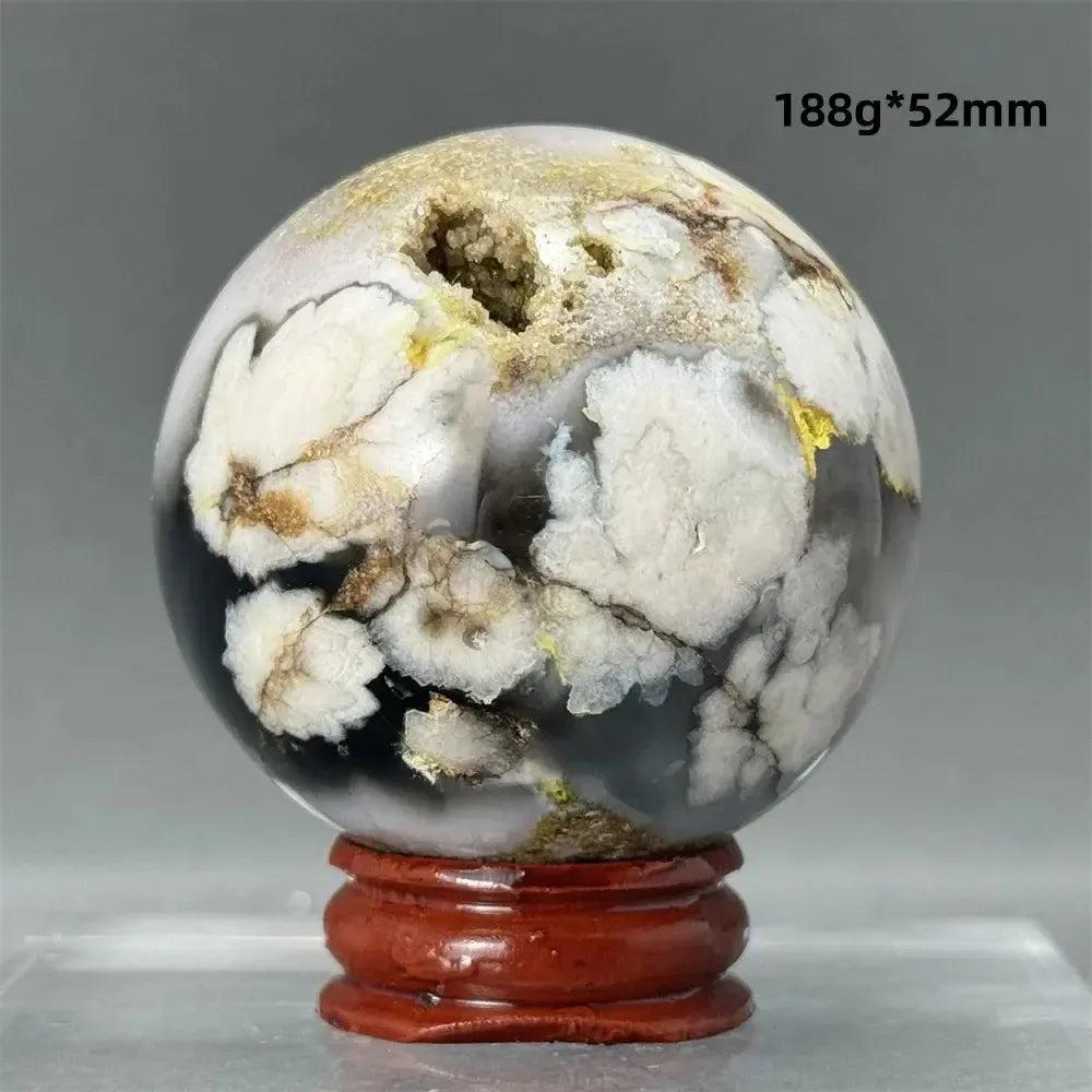 Black Cherry Blossom Agate Sphere with dramatic dark and light floral banding, 188g*52mm, on a wooden stand.