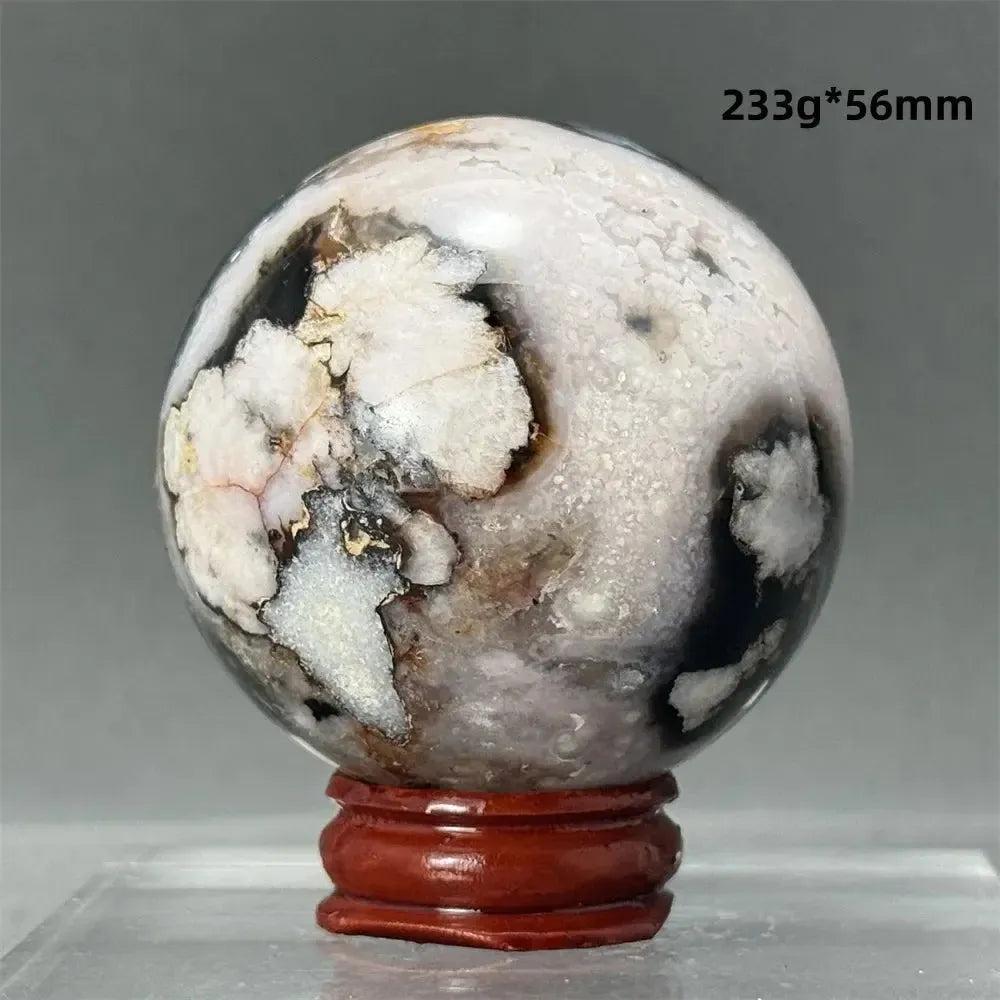 Black Cherry Blossom Agate Sphere, 233g, 56mm, with dramatic dark and light floral banding on a wooden stand.