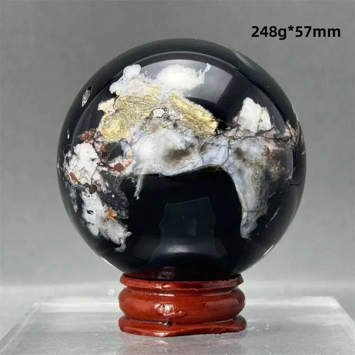 Black Cherry Blossom Agate Sphere, 248g 57mm, with dramatic dark and light floral banding on a wooden stand.
