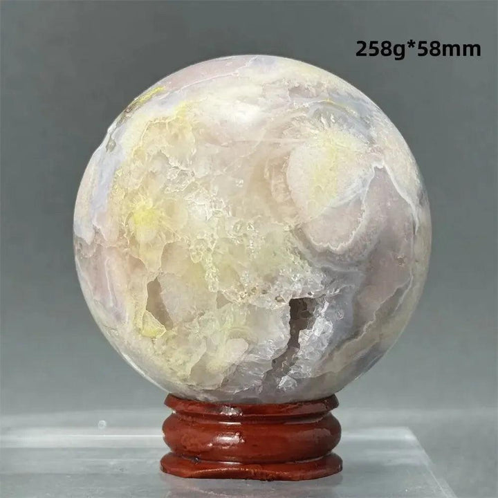 Black Cherry Blossom Agate Sphere, a striking crystal with deep charcoal, creamy white, and soft blush pink patterns.