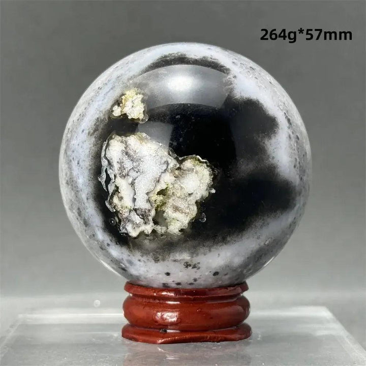 Black Cherry Blossom Agate Sphere, 264g, 57mm, with dramatic dark and light floral banding on a wooden stand.