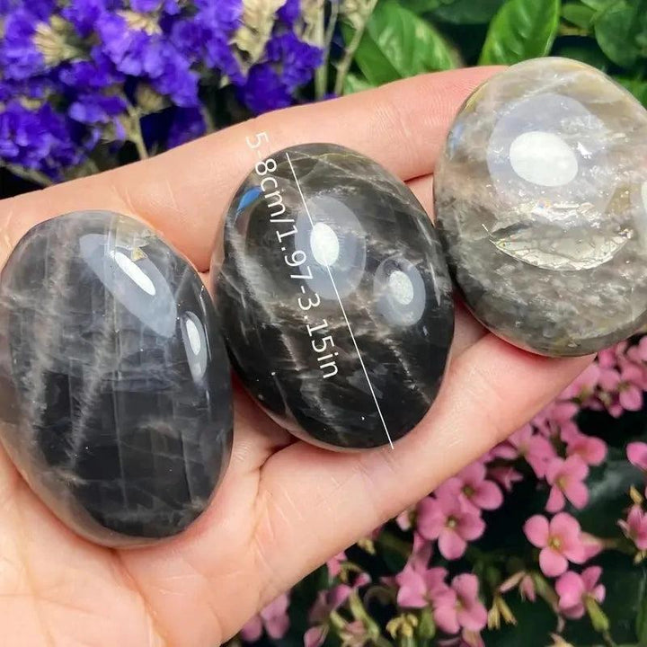 Polished black moonstone palm stones for relaxation, featuring smooth natural crystal textures in a 5-8cm handheld size.