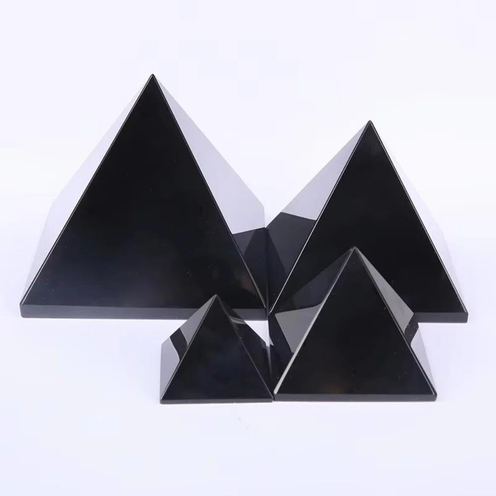 Black Obsidian Crystal Carved Protection Pyramids in various sizes, reflecting light for powerful grounding.