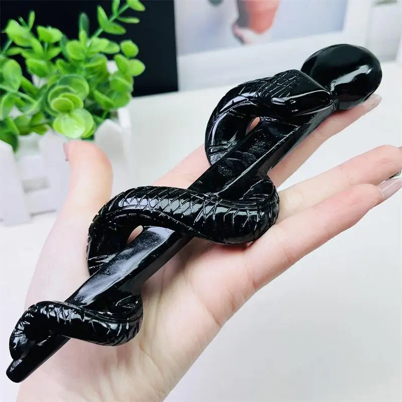 Hand-carved black obsidian snake doctor's staff, a glossy, protective symbol of healing, transformation, and ancient wisdom.