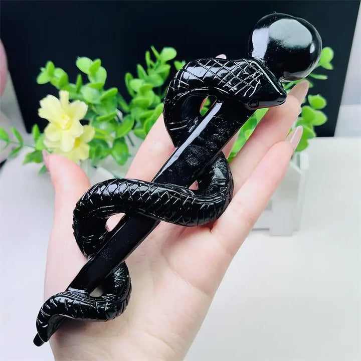 Hand-carved black obsidian snake doctor's staff, a glossy, protective symbol of healing, transformation, and wisdom.