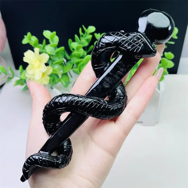 Hand-carved black obsidian snake staff, a glossy, protective symbol of healing and transformation for your collection.