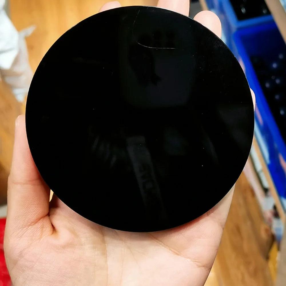 Polished black obsidian scrying mirror, a deeply reflective volcanic glass for protection, grounding, and truth-revealing energy.