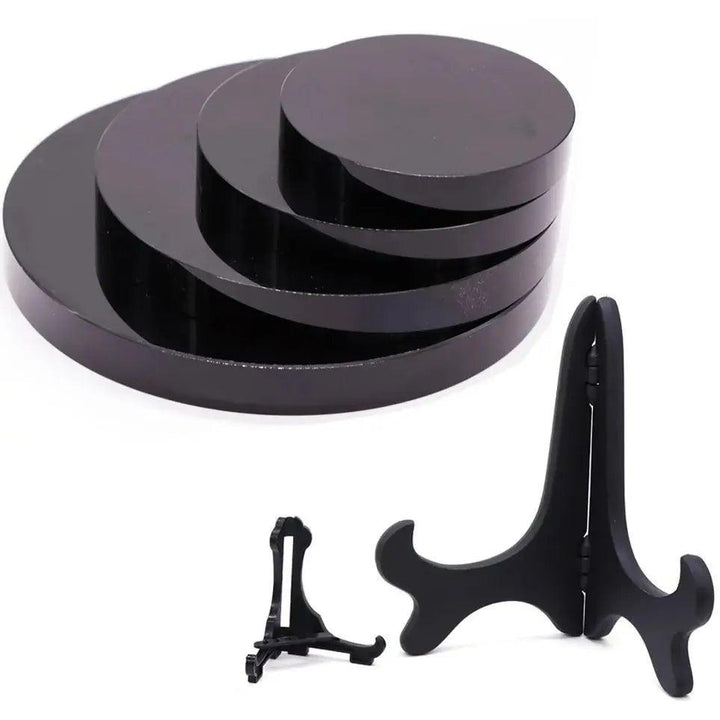 Polished black obsidian scrying mirrors in various sizes with two display stands, ideal for divination and shadow work.