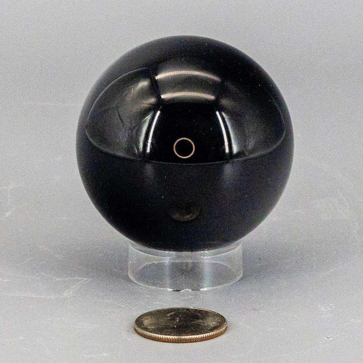 Deep black, polished Obsidian Sphere (50-60mm) reflecting light, radiating grounding and protective energy.