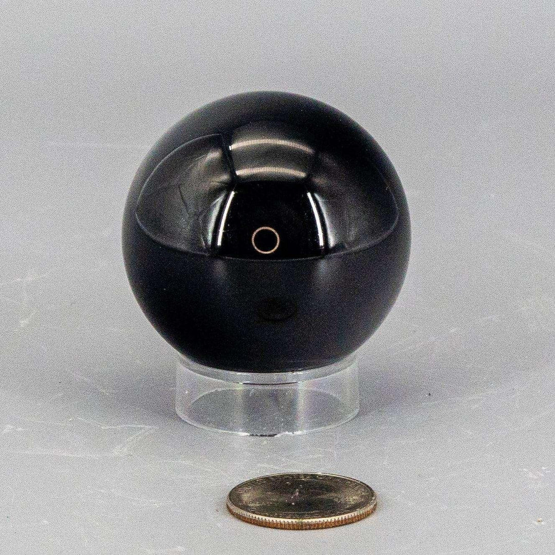 Deep black, polished Obsidian Sphere (50-60mm) reflecting light, radiating grounding and protective energy.