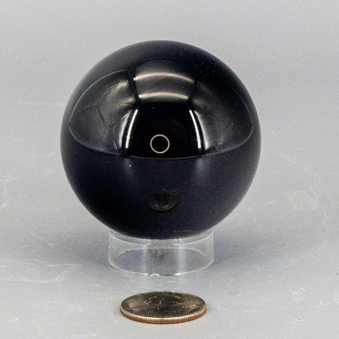 Deep black, polished Obsidian Sphere 50-60mm, reflecting light with a liquid quality, radiating grounding energy.