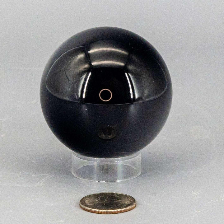 Deep black, polished Obsidian Sphere 50-60mm, reflecting light with a liquid quality, radiating grounding energy.