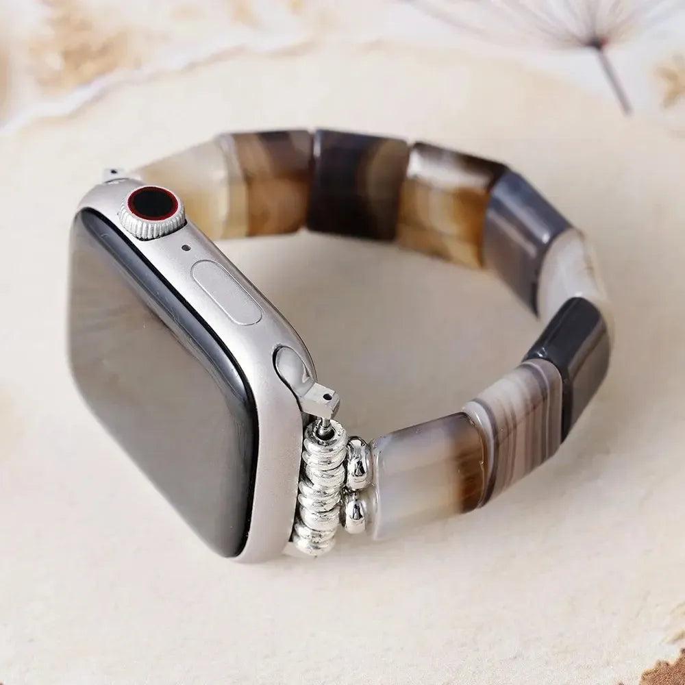 Crystal Destiny's Black Onyx beaded Apple Watch band with polished black, brown, and white onyx stones.