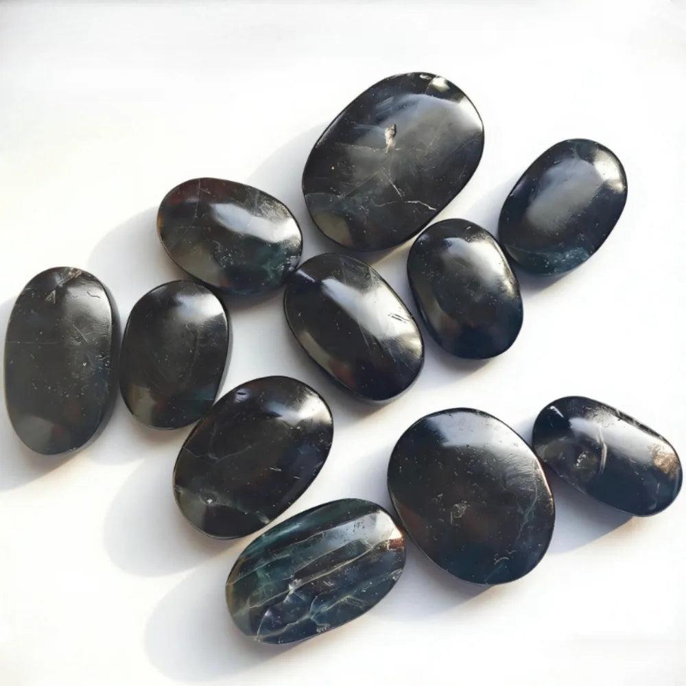 Polished black rose fluorite crystal palm stones for healing and meditation.