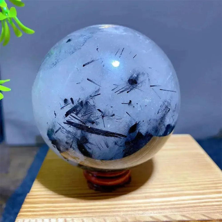 Mesmerizing Black Rutilated Quartz Crystal Sphere with dramatic black tourmaline inclusions, showcasing nature's artistry.
