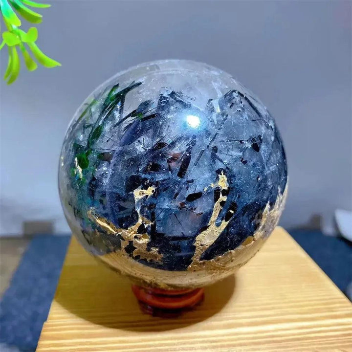 Mesmerizing Black Rutilated Quartz Crystal Sphere with dramatic black tourmaline and gold inclusions, perfect for energy work.