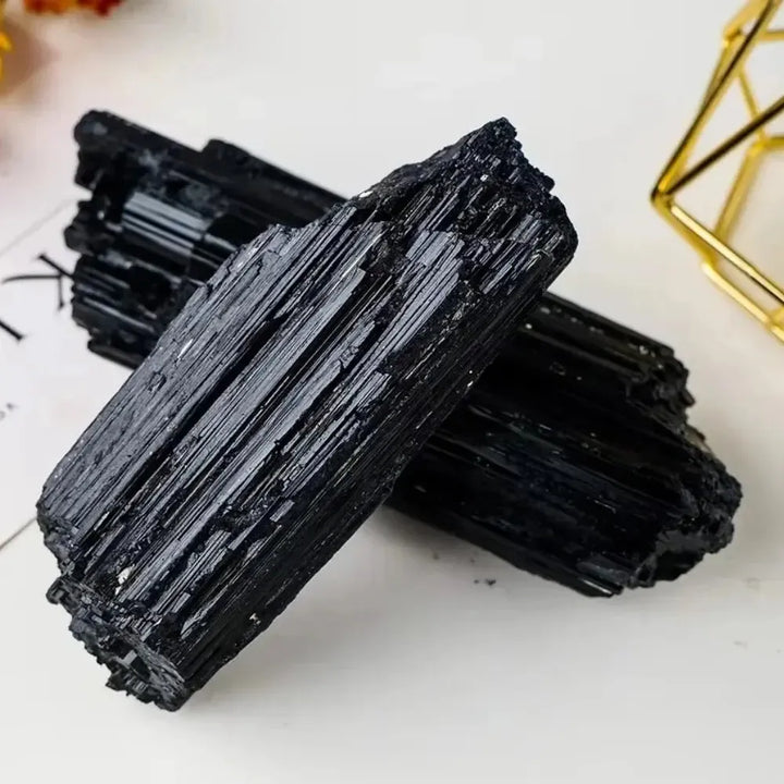 Large raw black tourmaline stone with natural vertical striations, perfect for healing energy and home decor.