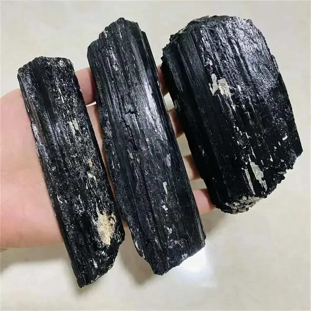 Large raw black tourmaline stones with natural, unpolished textures perfect for healing and home decor.