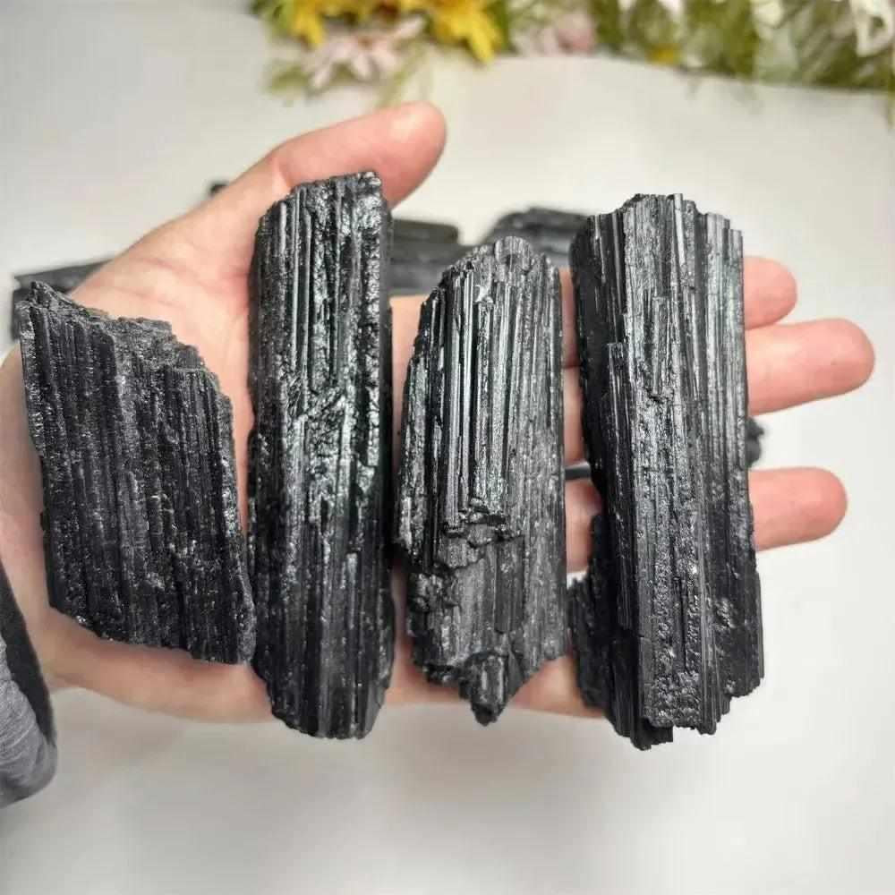 Large raw black tourmaline stones with natural vertical striations, perfect for healing, grounding, and home decor.