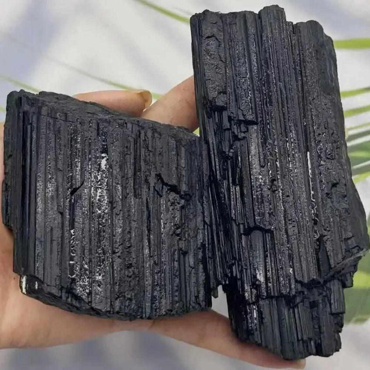 Large raw black tourmaline stone with natural vertical striations, perfect for grounding, healing, and home decor.
