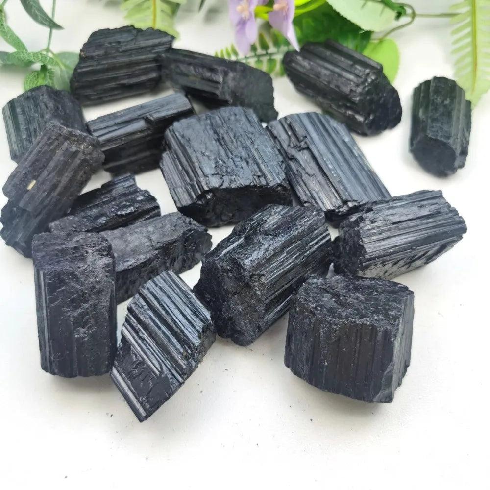 Raw Black Tourmaline crystal specimens featuring natural, striated black textures for powerful grounding and protection.
