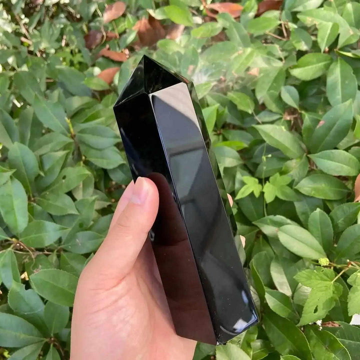 Glossy Black Tourmaline tower with a faceted point, perfect for grounding and protection in any meditation space.