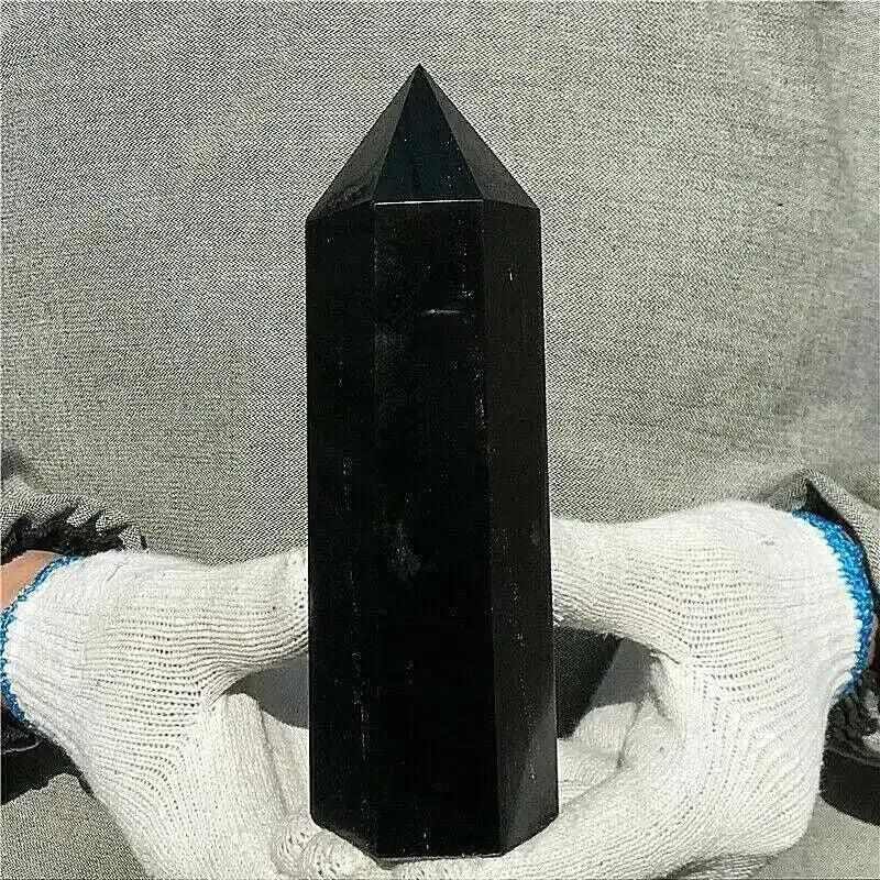 Glossy black tourmaline tower with a faceted point, perfect for grounding and protection in any meditation space.