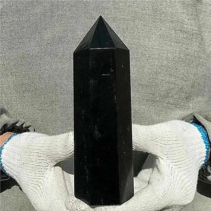 Glossy black tourmaline tower with a faceted point, perfect for grounding and protection in any meditation space.