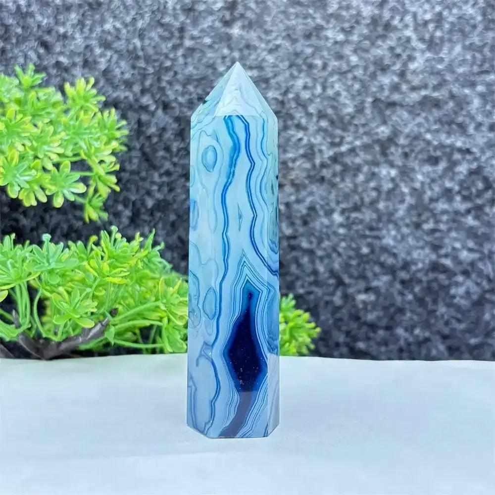 Polished blue agate hexagonal tower with soothing blue banding, perfect for throat chakra healing and calm focus.