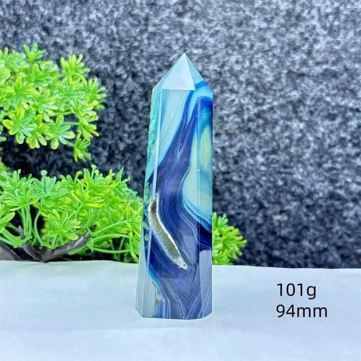 Polished blue agate hexagonal tower with soothing blue banding, perfect for Throat Chakra healing and desk decor.