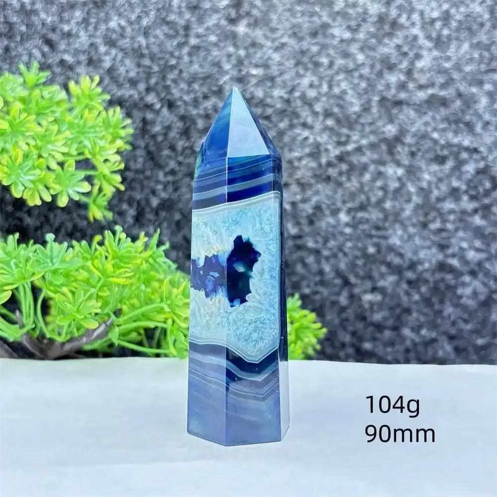 Polished blue agate hexagonal tower with soothing blue banding and a natural crystal geode center for calm energy.