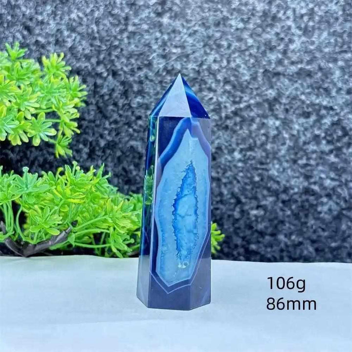Polished blue agate hexagonal tower with natural banding, perfect for throat chakra healing and calming desk decor.