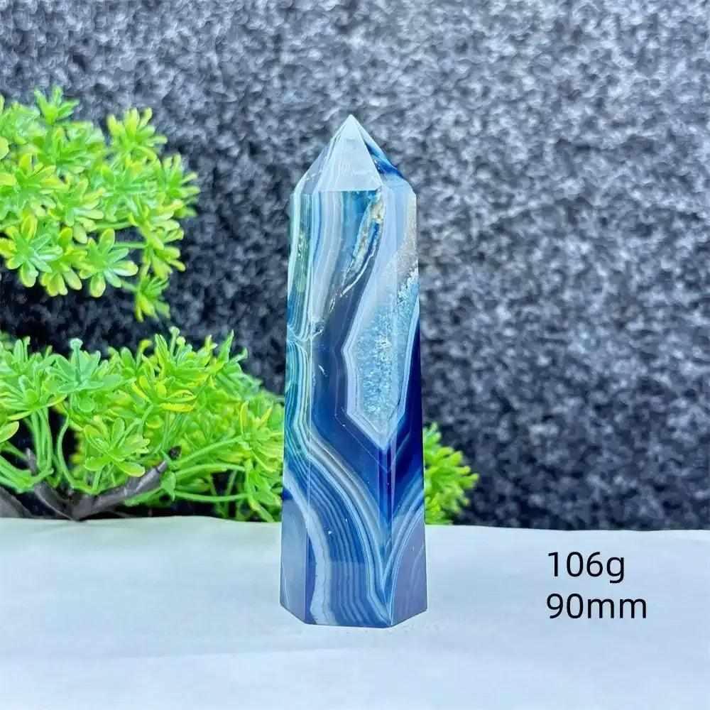 Polished blue agate hexagonal tower with soothing blue banding, perfect for throat chakra healing and calm communication.