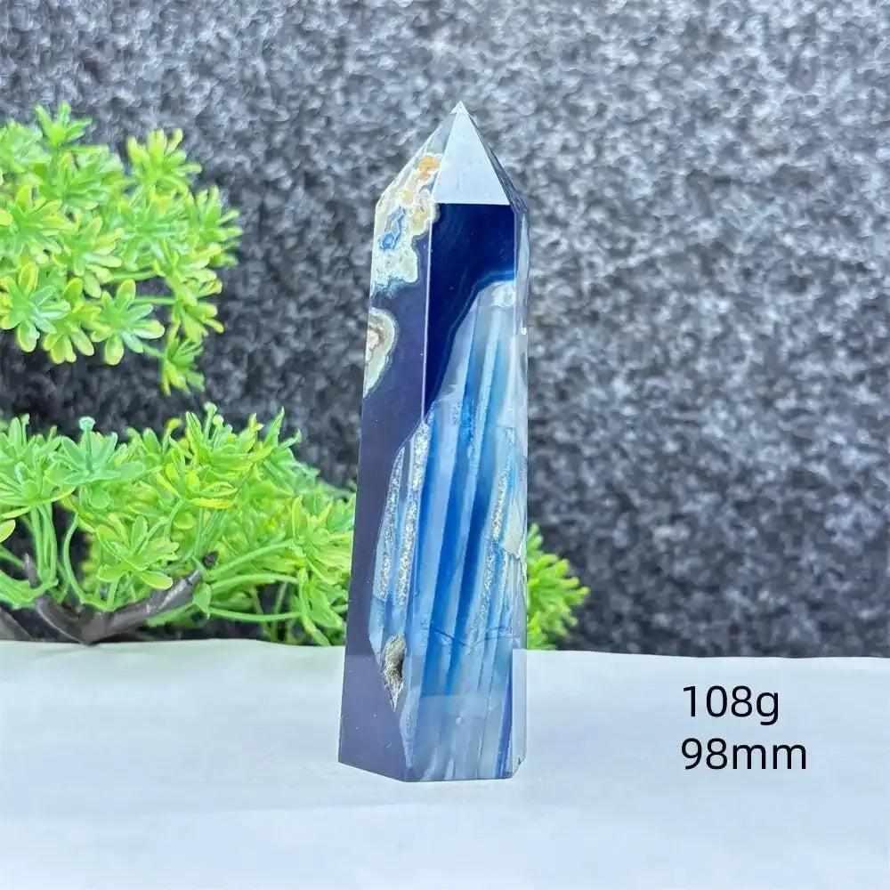 Polished blue agate hexagonal tower with soothing blue banding, perfect for throat chakra healing and calm focus.