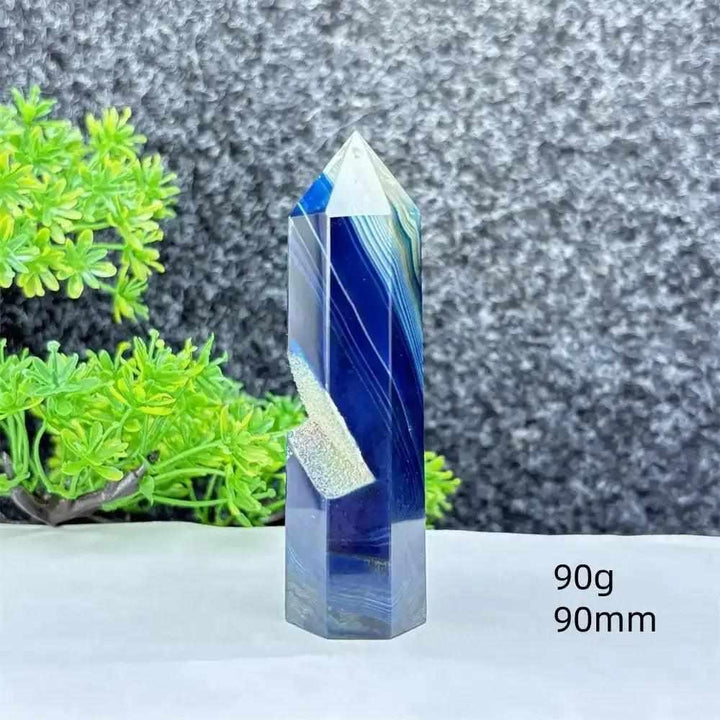 Polished blue agate hexagonal tower with soothing blue banding, perfect for throat chakra healing and calm focus.