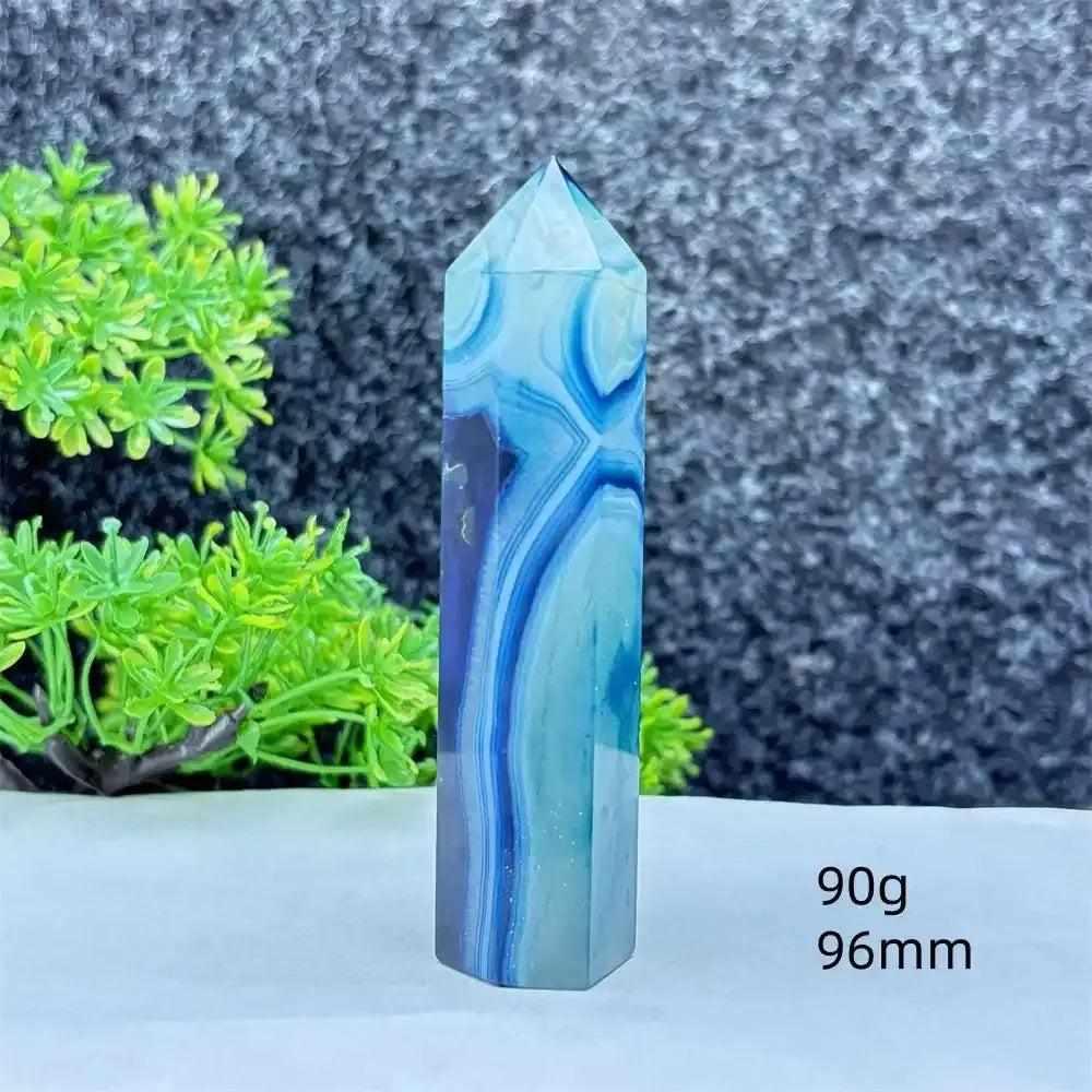 Polished blue agate hexagonal tower with soothing blue banding, perfect for Throat Chakra healing and desk decor.